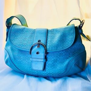 Coach purse in the color light blue.